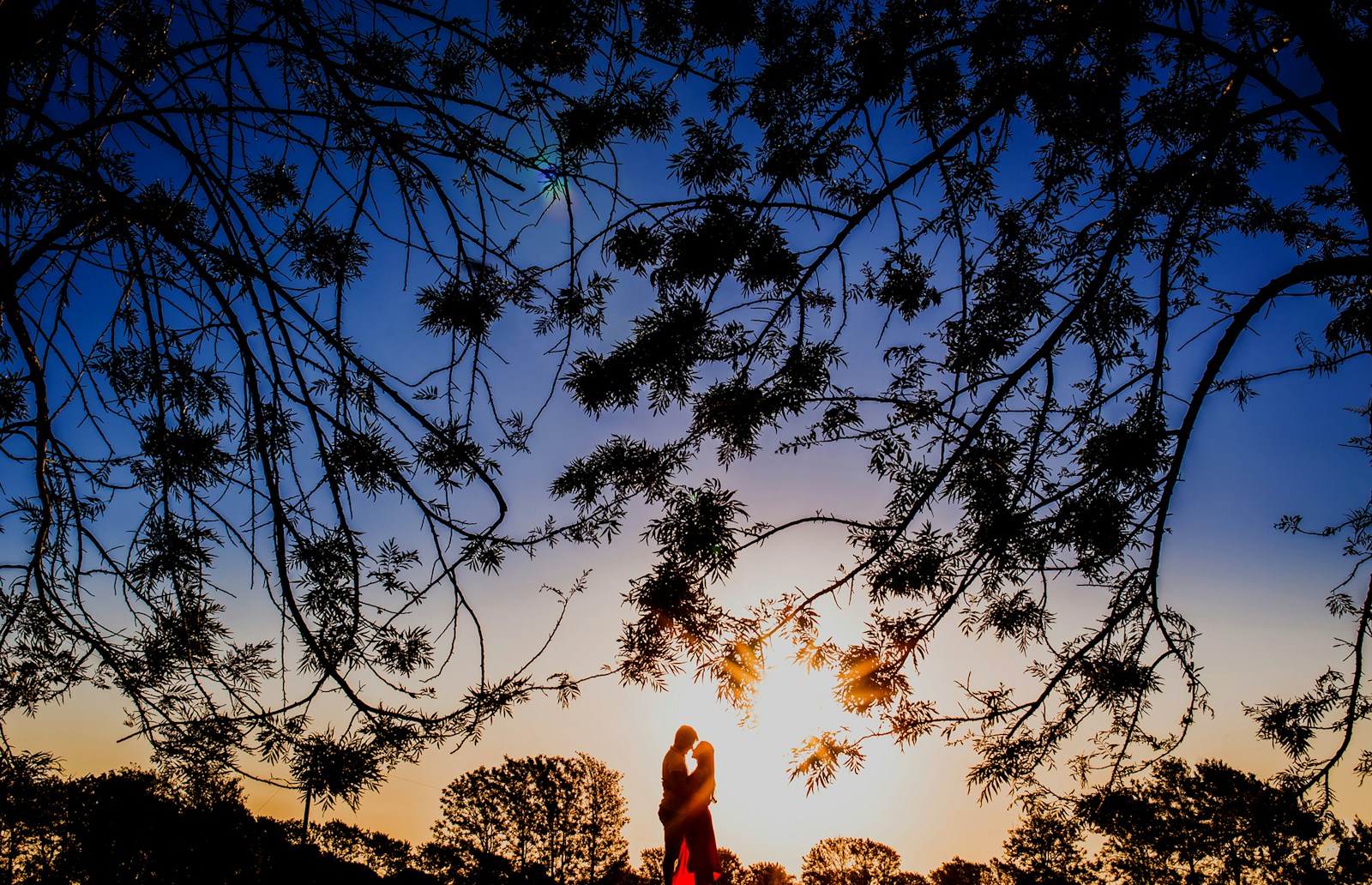 silhouette photo of man and woman hugging each other